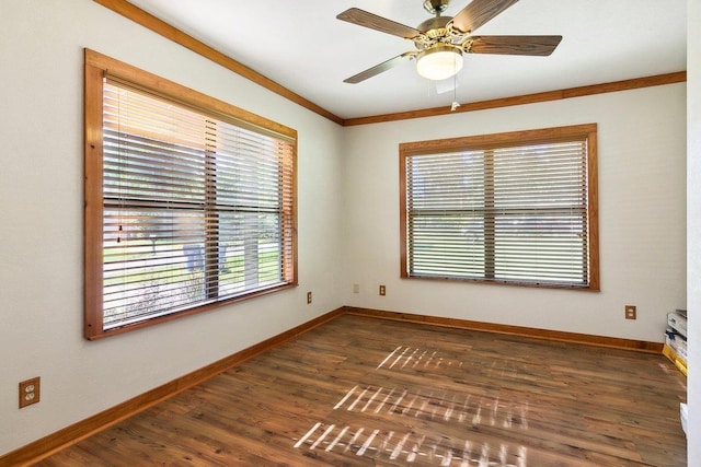 empty room with dark hardwood / wood-style flooring, ceiling fan, and crown molding