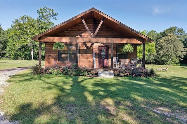 exterior space featuring a lawn and covered porch