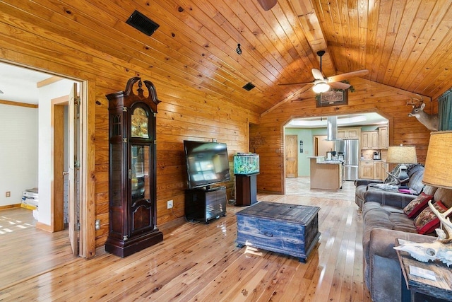 living room featuring ceiling fan, wooden ceiling, light hardwood / wood-style floors, lofted ceiling, and wood walls