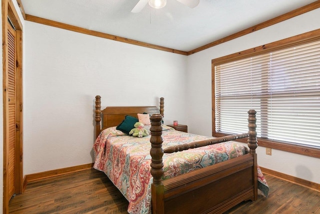 bedroom with ceiling fan, dark hardwood / wood-style flooring, crown molding, and a closet