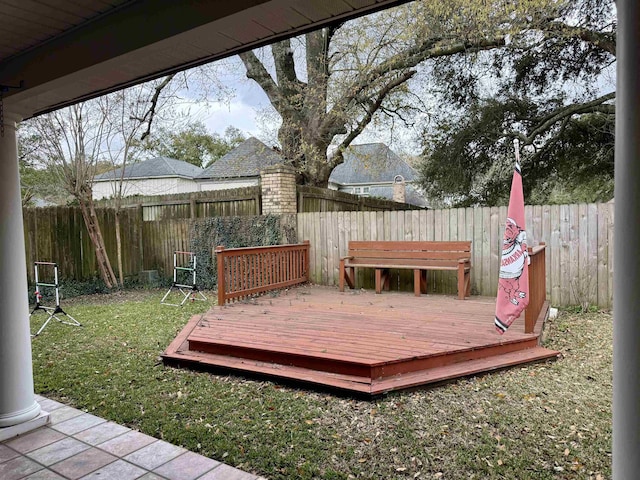 wooden terrace featuring a yard and a fenced backyard