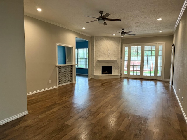 5835 Calder Ave, Beaumont, TX 77706 - unfurnished living room featuring crown molding, a ceiling fan, dark wood-type flooring, baseboards, and recessed lighting