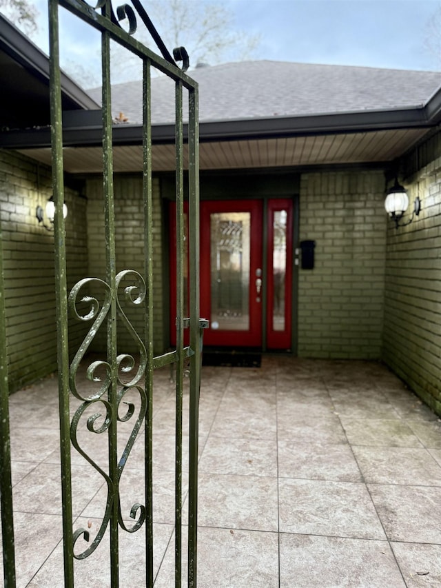 doorway to property with brick siding