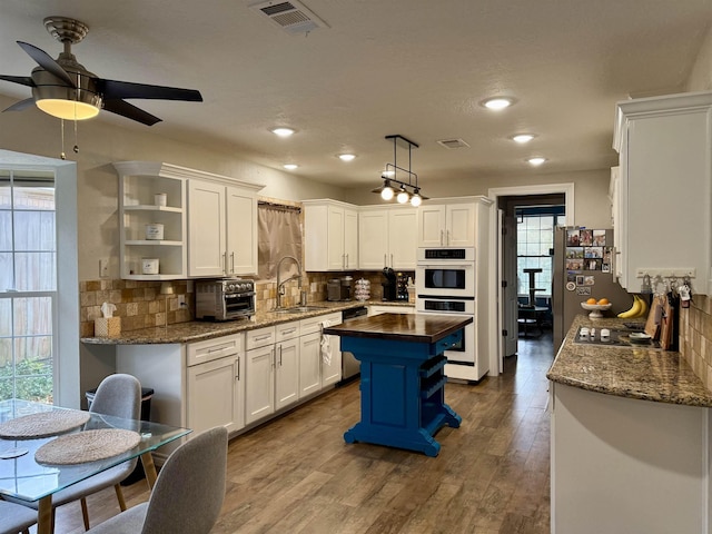 5835 Calder Ave, Beaumont, TX 77706 - kitchen with open shelves, butcher block countertops, a sink, white cabinets, and a ceiling fan