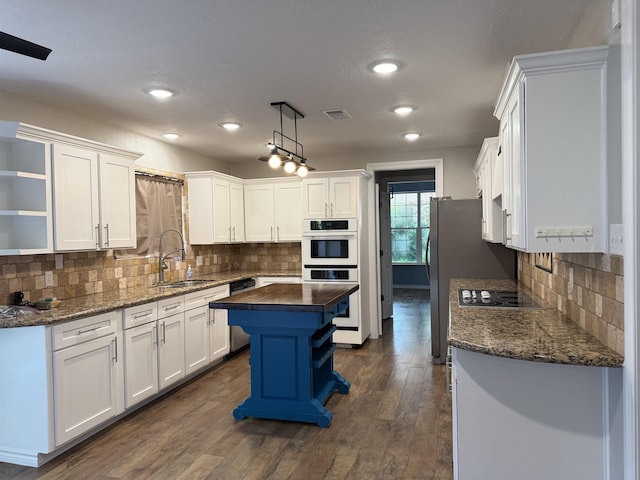 5835 Calder Ave, Beaumont, TX 77706 - kitchen with a sink, open shelves, white cabinets, and recessed lighting