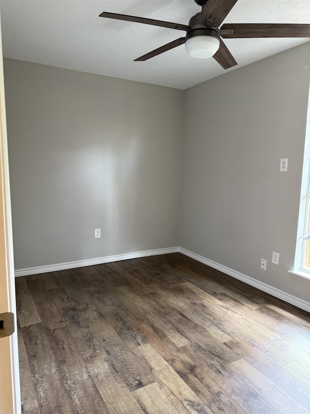 5835 Calder Ave, Beaumont, TX 77706 - unfurnished room featuring ceiling fan, dark wood-style flooring, and baseboards