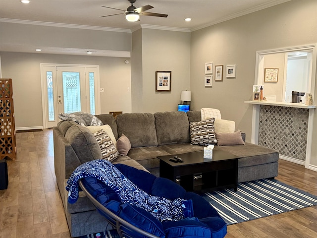 living area with ornamental molding, recessed lighting, wood-type flooring, baseboards, and ceiling fan