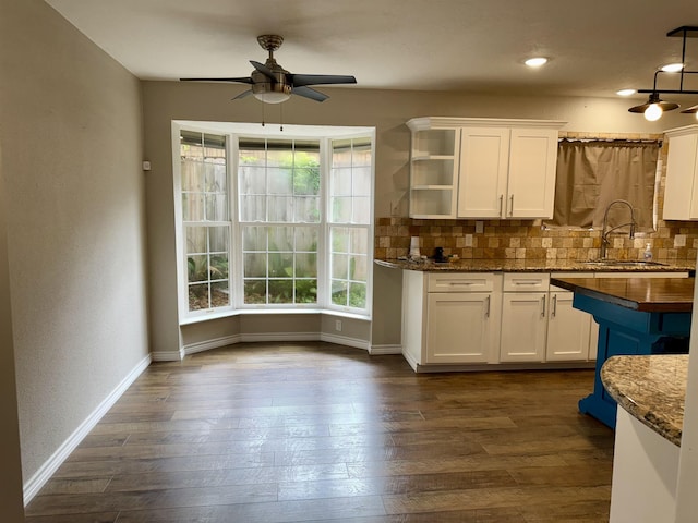 5835 Calder Ave, Beaumont, TX 77706 - kitchen with ceiling fan, a sink, backsplash, white cabinetry, and recessed lighting