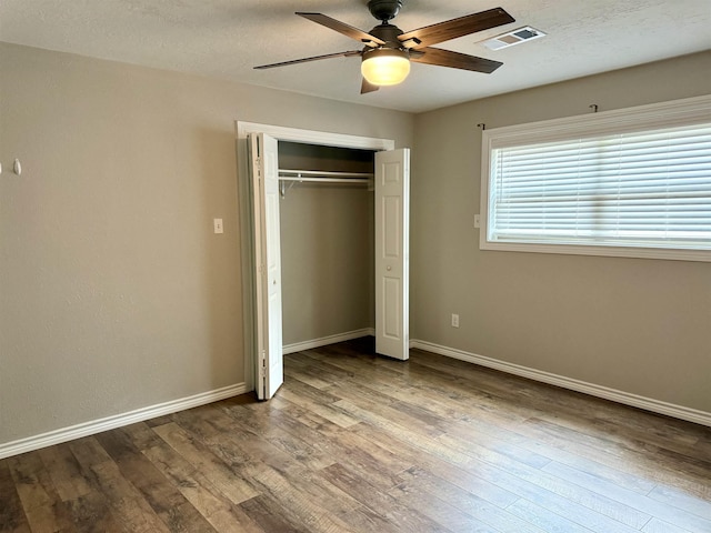 5835 Calder Ave, Beaumont, TX 77706 - unfurnished bedroom with wood finished floors, a closet, baseboards, and ceiling fan