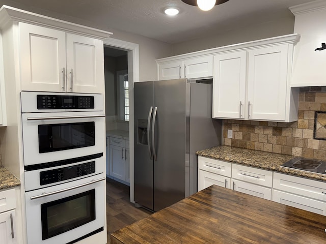 5835 Calder Ave, Beaumont, TX 77706 - kitchen with double oven, stainless steel fridge, butcher block countertops, white cabinetry, and recessed lighting