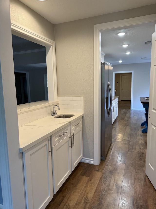 5835 Calder Ave, Beaumont, TX 77706 - bathroom featuring wood-type flooring, tasteful backsplash, vanity, and baseboards