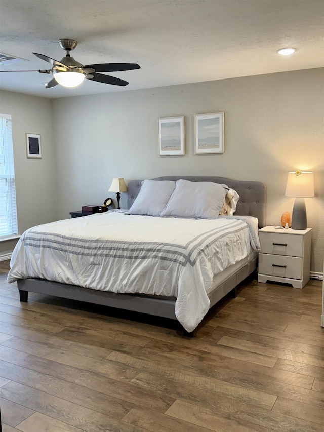 bedroom with hardwood / wood-style floors and a ceiling fan