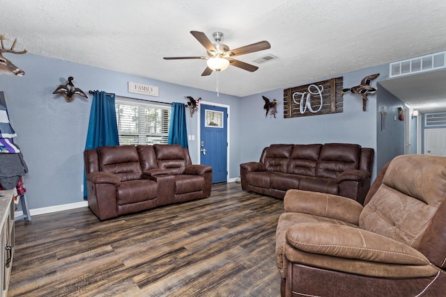 living area featuring dark wood-style floors, visible vents, a textured ceiling, and a ceiling fan