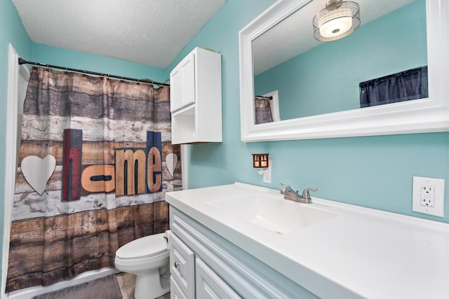 full bathroom featuring toilet, a textured ceiling, and vanity