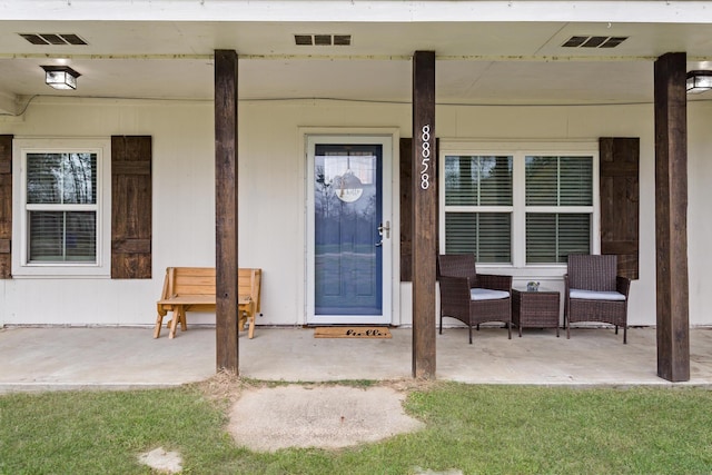 property entrance with visible vents and a porch