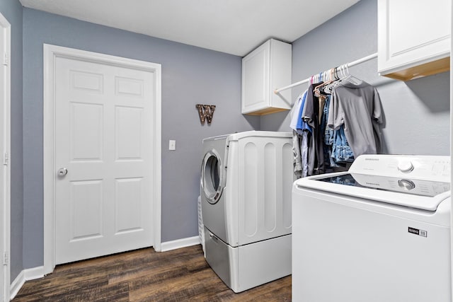 laundry area featuring cabinet space, separate washer and dryer, dark wood-style flooring, and baseboards