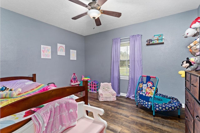 bedroom featuring a textured ceiling, ceiling fan, and wood finished floors