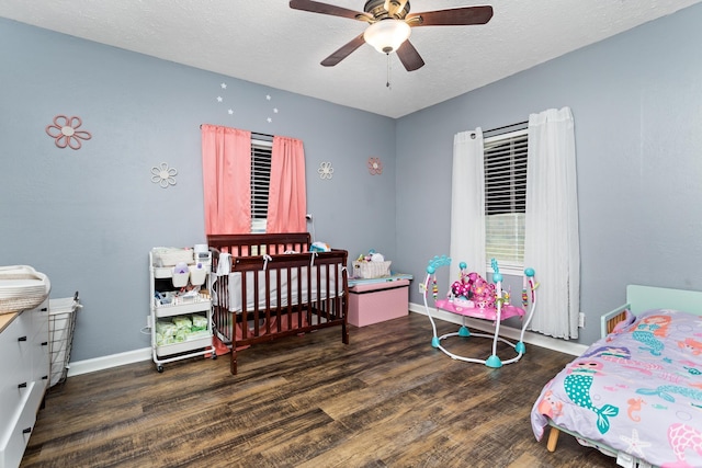 bedroom featuring baseboards, a textured ceiling, wood finished floors, and a ceiling fan