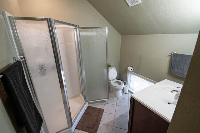 bathroom with tile patterned flooring, lofted ceiling, toilet, a shower with door, and vanity