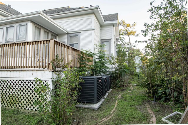 2108 Harrison Ave, Beaumont, TX 77701 - view of property exterior with a wooden deck and a shingled roof
