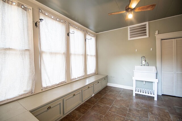 2108 Harrison Ave, Beaumont, TX 77701 - unfurnished dining area featuring a ceiling fan and dark stone finish floors
