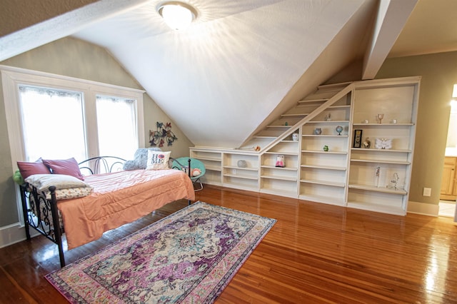 bedroom featuring dark wood-type flooring and lofted ceiling