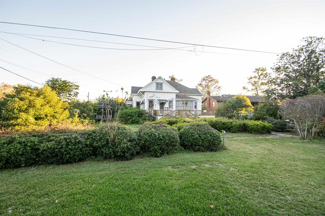 2108 Harrison Ave, Beaumont, TX 77701 - view of front facade with a chimney and a front yard