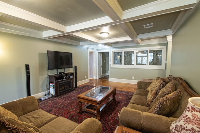 living room with ornate columns, coffered ceiling, crown molding, hardwood / wood-style flooring, and beamed ceiling