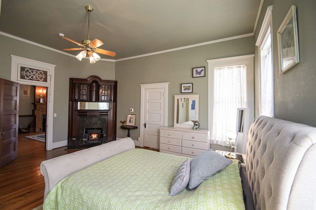 bedroom featuring ceiling fan, dark hardwood / wood-style floors, and ornamental molding