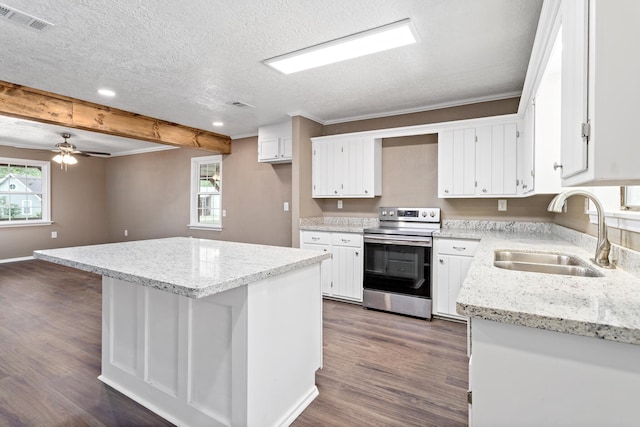 kitchen featuring stainless steel range with electric stovetop, a kitchen island, white cabinetry, and sink