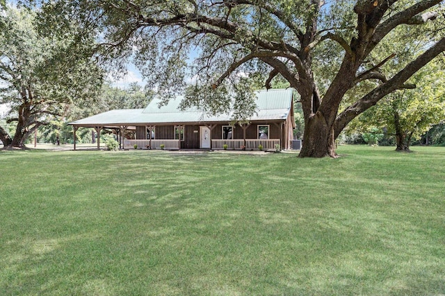 view of front facade with a carport and a front lawn