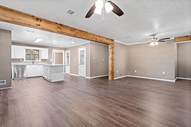 unfurnished living room featuring a textured ceiling, dark hardwood / wood-style flooring, ceiling fan, and sink