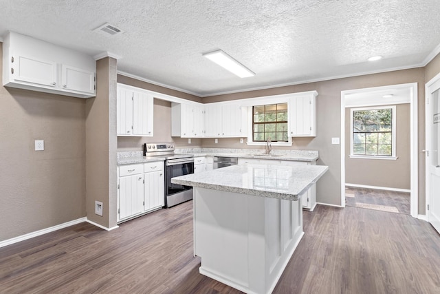 kitchen featuring a center island, dark wood-type flooring, a textured ceiling, appliances with stainless steel finishes, and white cabinetry