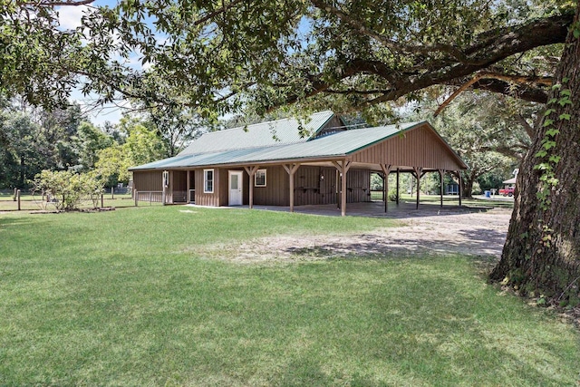 rear view of property with a lawn