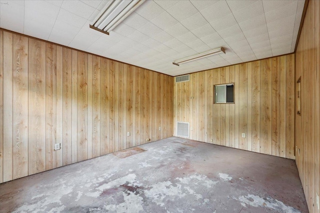 2432 Wespine Dr, Beaumont, TX 77707 - spare room featuring concrete flooring and wood walls