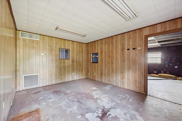 2432 Wespine Dr, Beaumont, TX 77707 - spare room with unfinished concrete floors and wooden walls