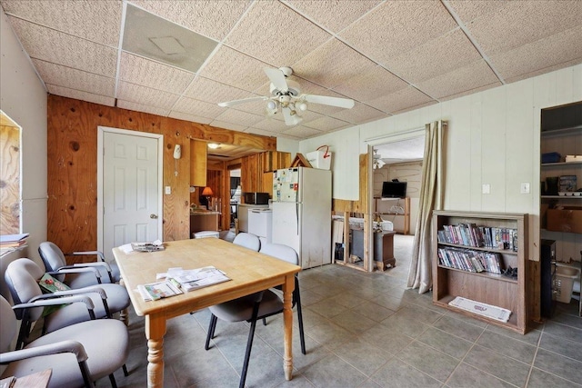 2432 Wespine Dr, Beaumont, TX 77707 - dining space with ceiling fan, wooden walls, and tile patterned floors