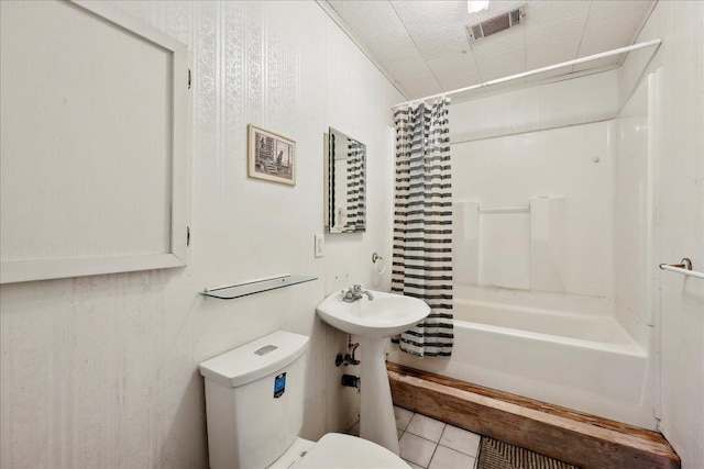 2432 Wespine Dr, Beaumont, TX 77707 - bathroom with toilet, tile patterned floors, and shower / tub combo with curtain
