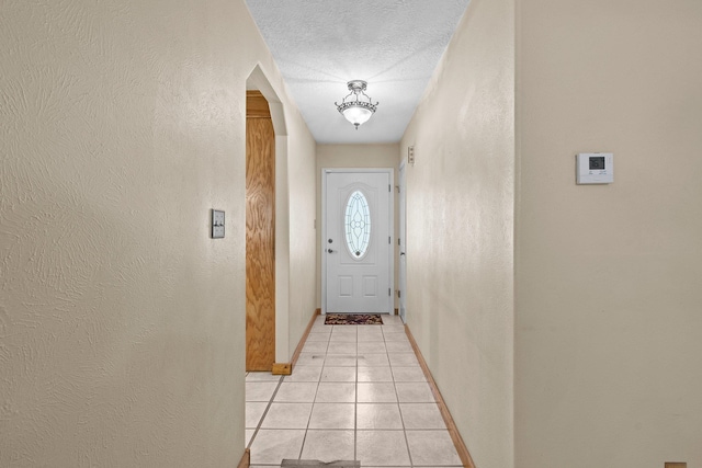 5434 Airline Rd, Silsbee, TX 77656 - entryway with baseboards, light tile patterned floors, a textured wall, and a textured ceiling