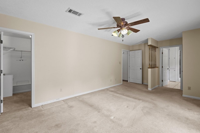 5434 Airline Rd, Silsbee, TX 77656 - unfurnished bedroom with carpet, baseboards, a spacious closet, a ceiling fan, and a closet