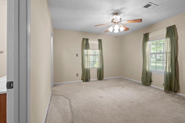 5434 Airline Rd, Silsbee, TX 77656 - carpeted spare room featuring healthy amount of natural light, a ceiling fan, a textured ceiling, and baseboards