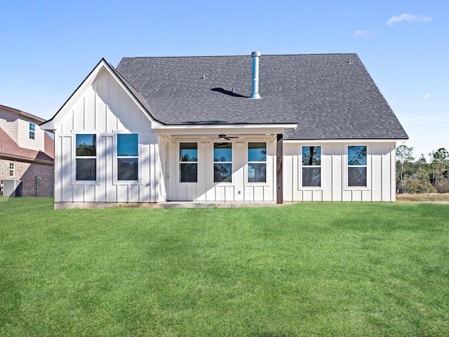 back of house featuring a lawn, board and batten siding, and a shingled roof