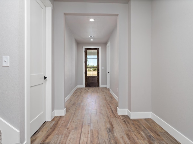 entryway featuring recessed lighting, baseboards, and wood finished floors