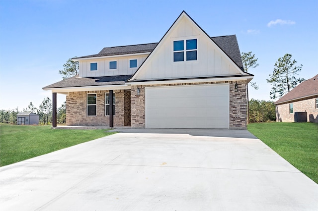 view of front of home featuring driveway, brick siding, board and batten siding, and a front yard