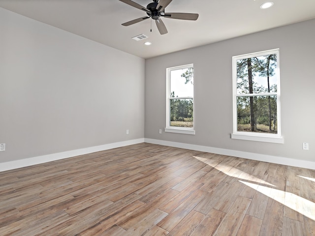 spare room featuring recessed lighting, baseboards, ceiling fan, and light wood finished floors