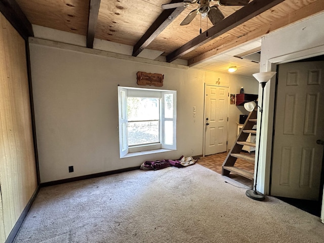 interior space featuring beam ceiling, ceiling fan, and wooden ceiling