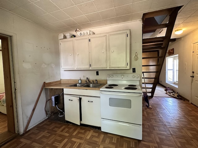 kitchen with white cabinetry, dark parquet flooring, electric stove, and sink