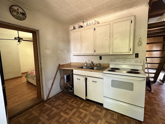 kitchen featuring dark parquet flooring, electric range, and sink