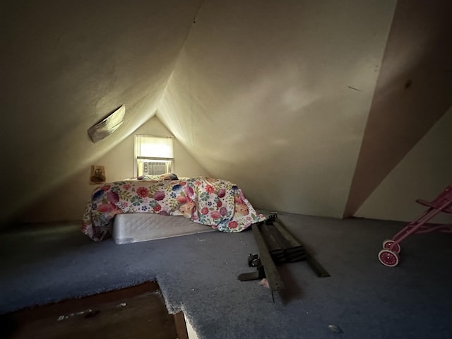 unfurnished bedroom featuring cooling unit and vaulted ceiling