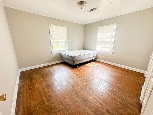 unfurnished bedroom with hardwood / wood-style floors